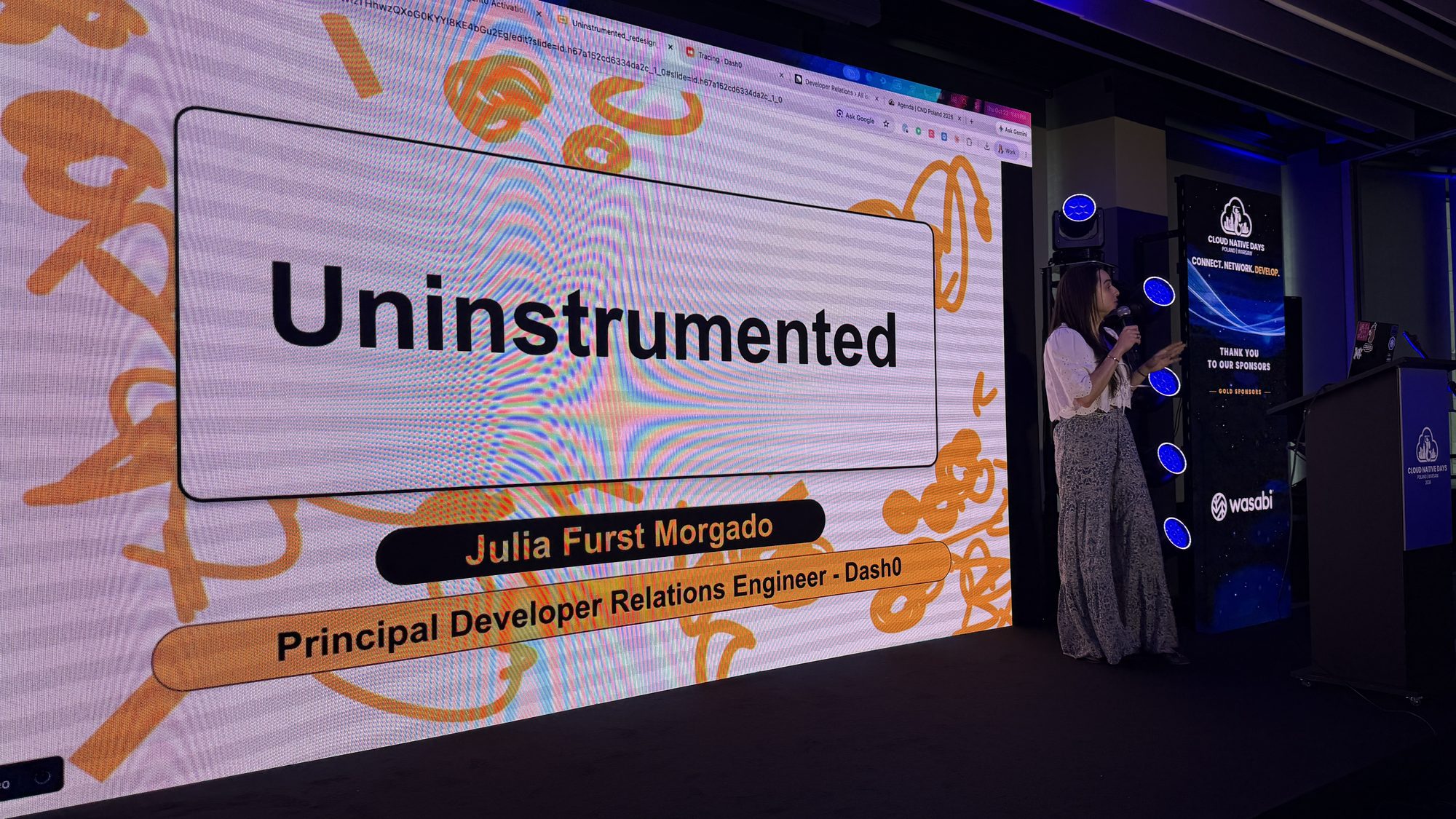 Julia Furst Morgado next to her title slide: Uninstrumented, Julia Furst Morgado, Principal Developer Relations Engineer, Dash0