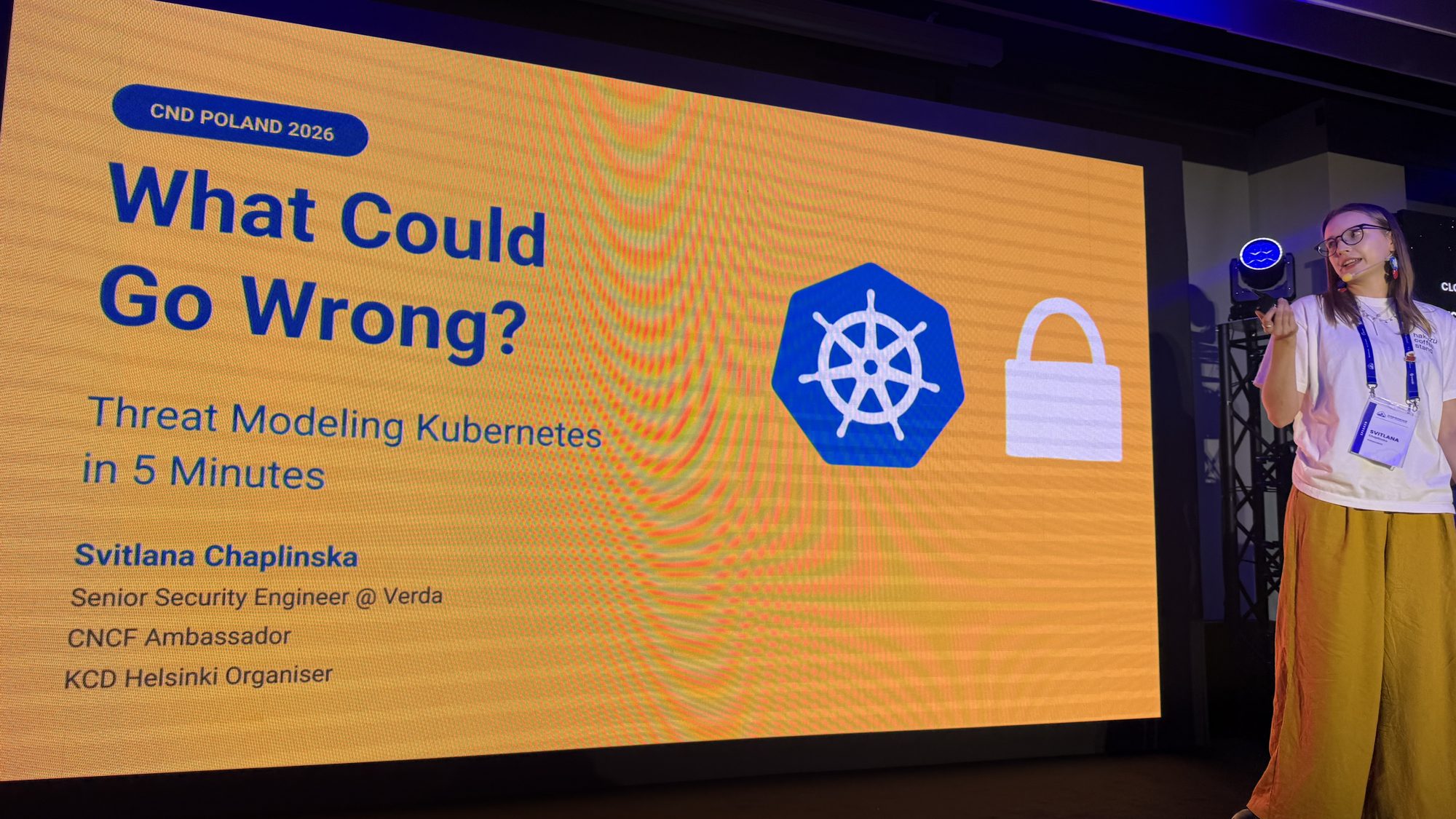 Svitlana Chaplinska next to her title slide: What Could Go Wrong? Threat Modeling Kubernetes in 5 Minutes
