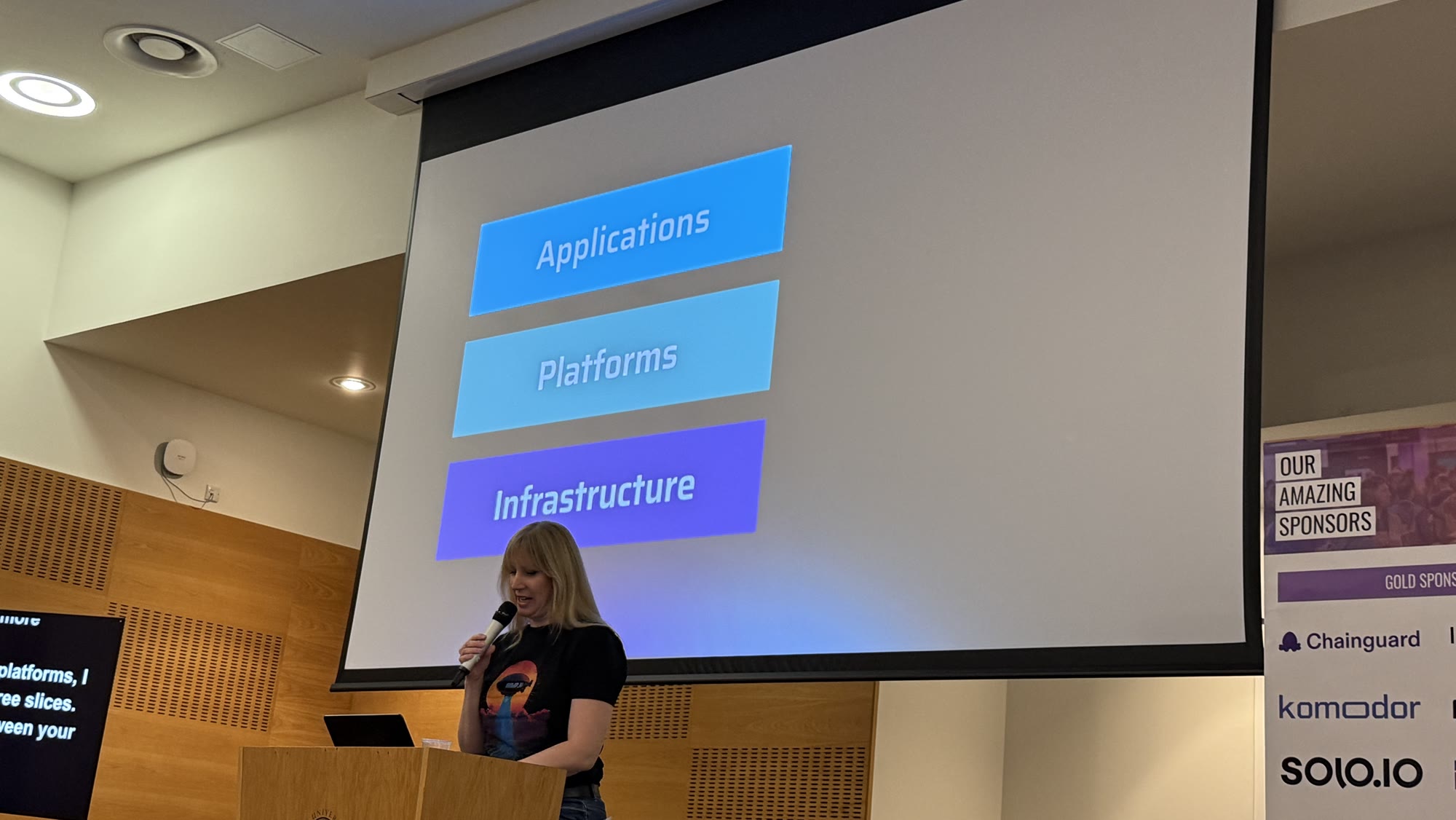 Hannah Foxwell next to a slide with three stacked boxes: Applications, Platforms, Infrastructure