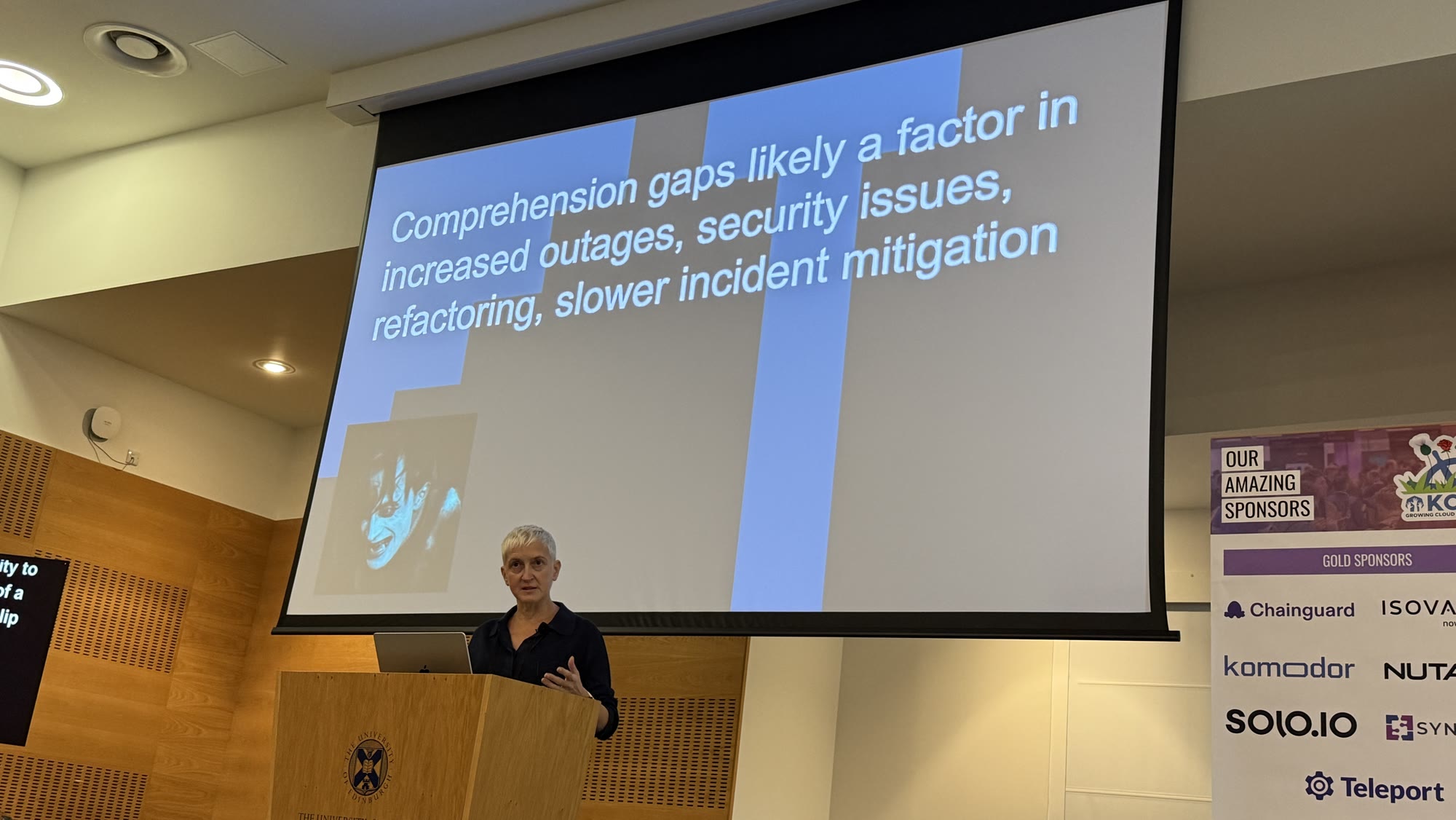 Sue Smith in front of a slide: Comprehension gaps likely a factor in increased outages, security issues, refactoring, slower incident mitigation