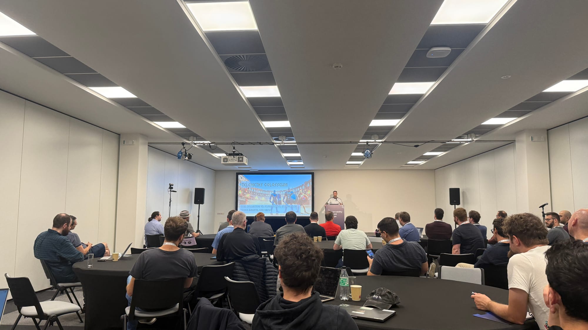 A full room watching Henrik Rexed's talk, with the Telemetry Colosseum title slide on screen