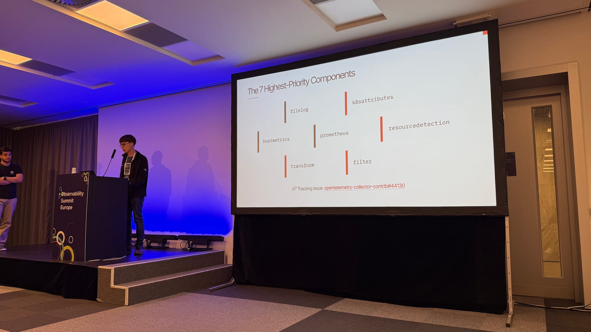 Slide titled The 7 Highest-Priority Components: filelog, hostmetrics and prometheus receivers, and k8sattributes, resourcedetection, transform and filter processors, with tracking issue opentelemetry-collector-contrib#44130