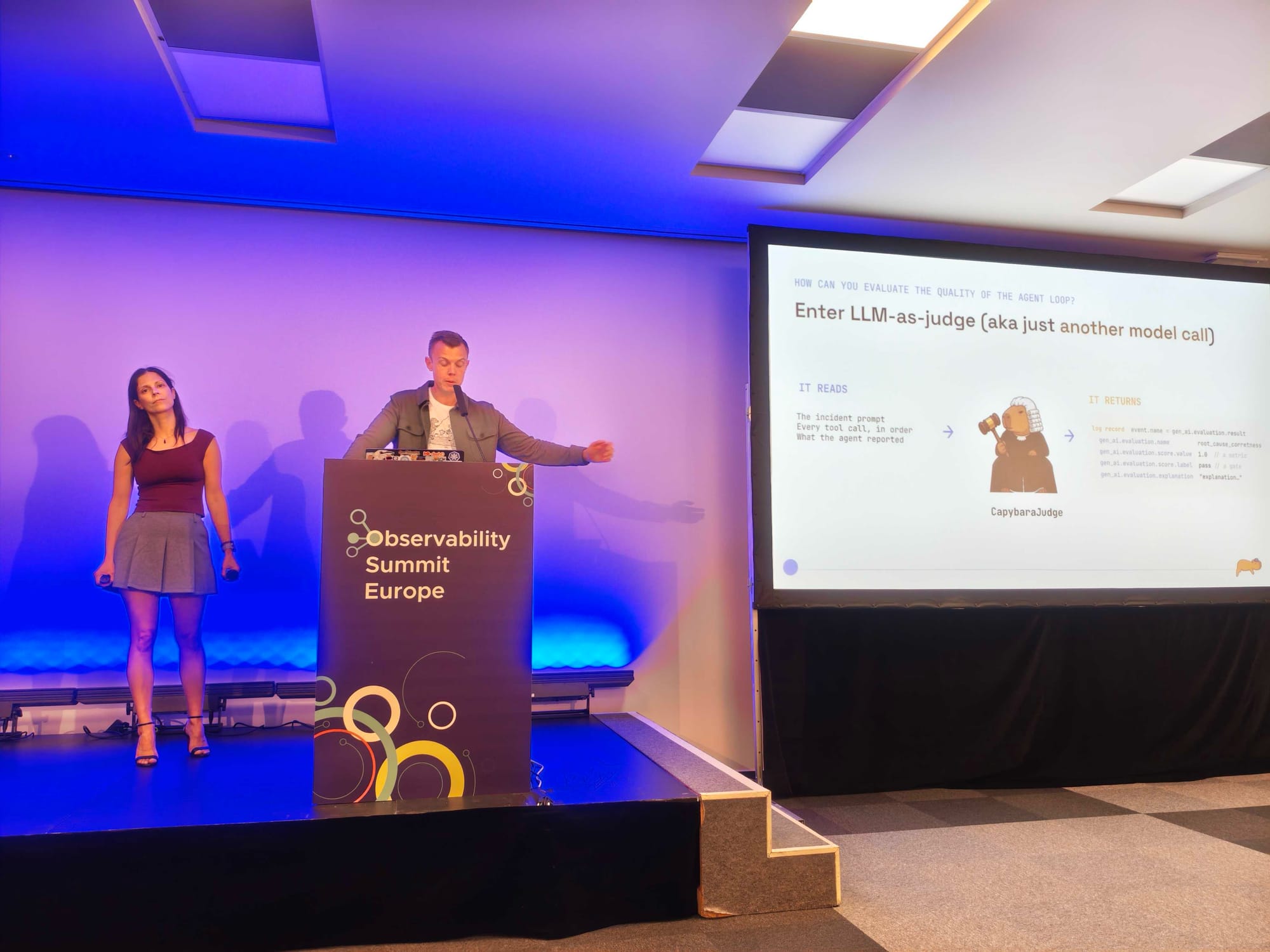 Kasper next to a slide titled Enter LLM-as-judge, aka just another model call, with a capybara judge in a wig returning a gen_ai.evaluation.result log record