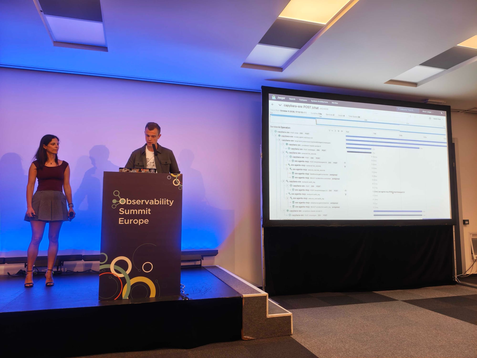 Kasper giving the demo next to a Jaeger trace of capybara-sre POST /chat, with model completions and MCP tool calls to list_records and audit_log nested underneath