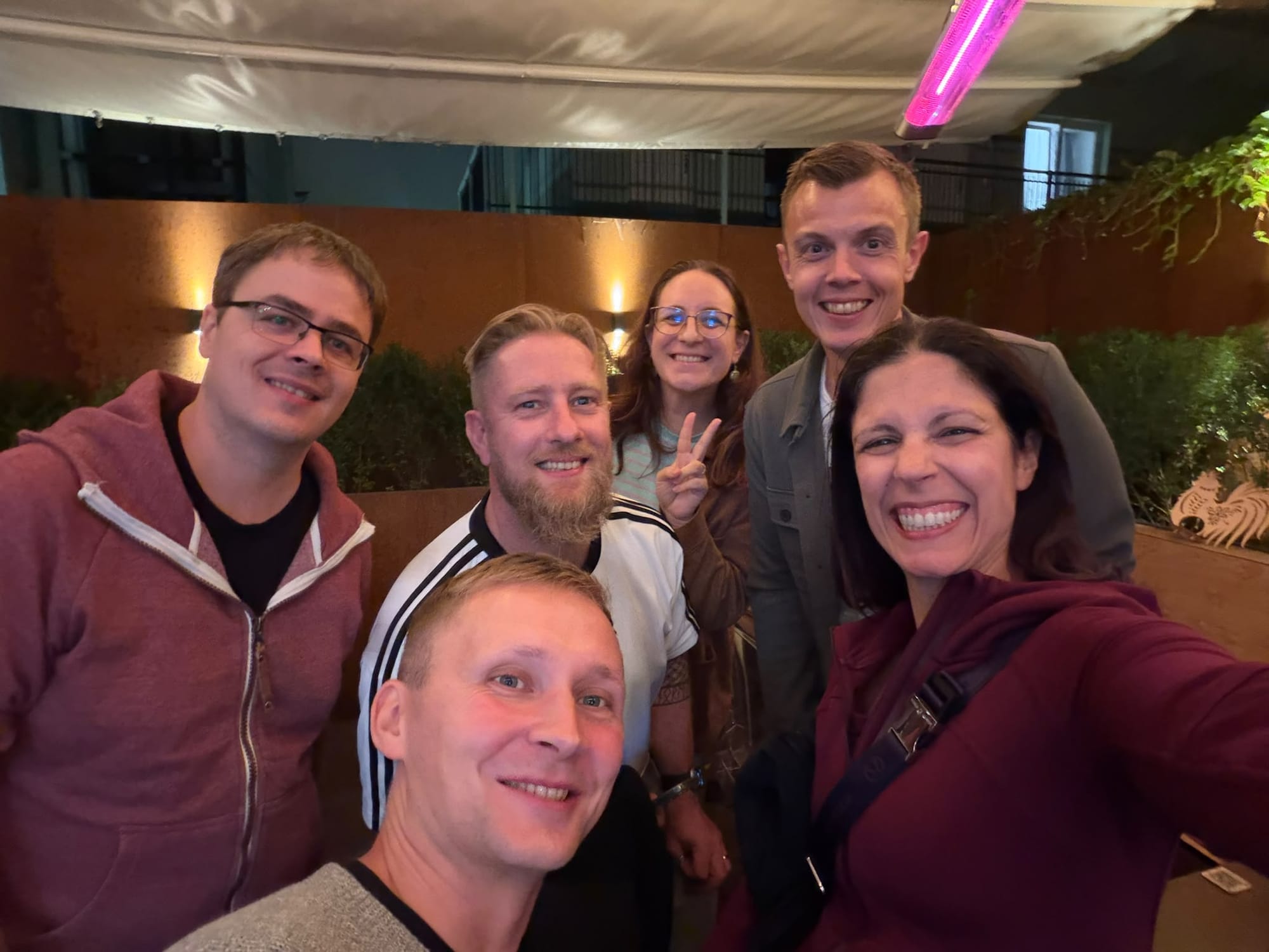 The six of us taking a group selfie outside at night