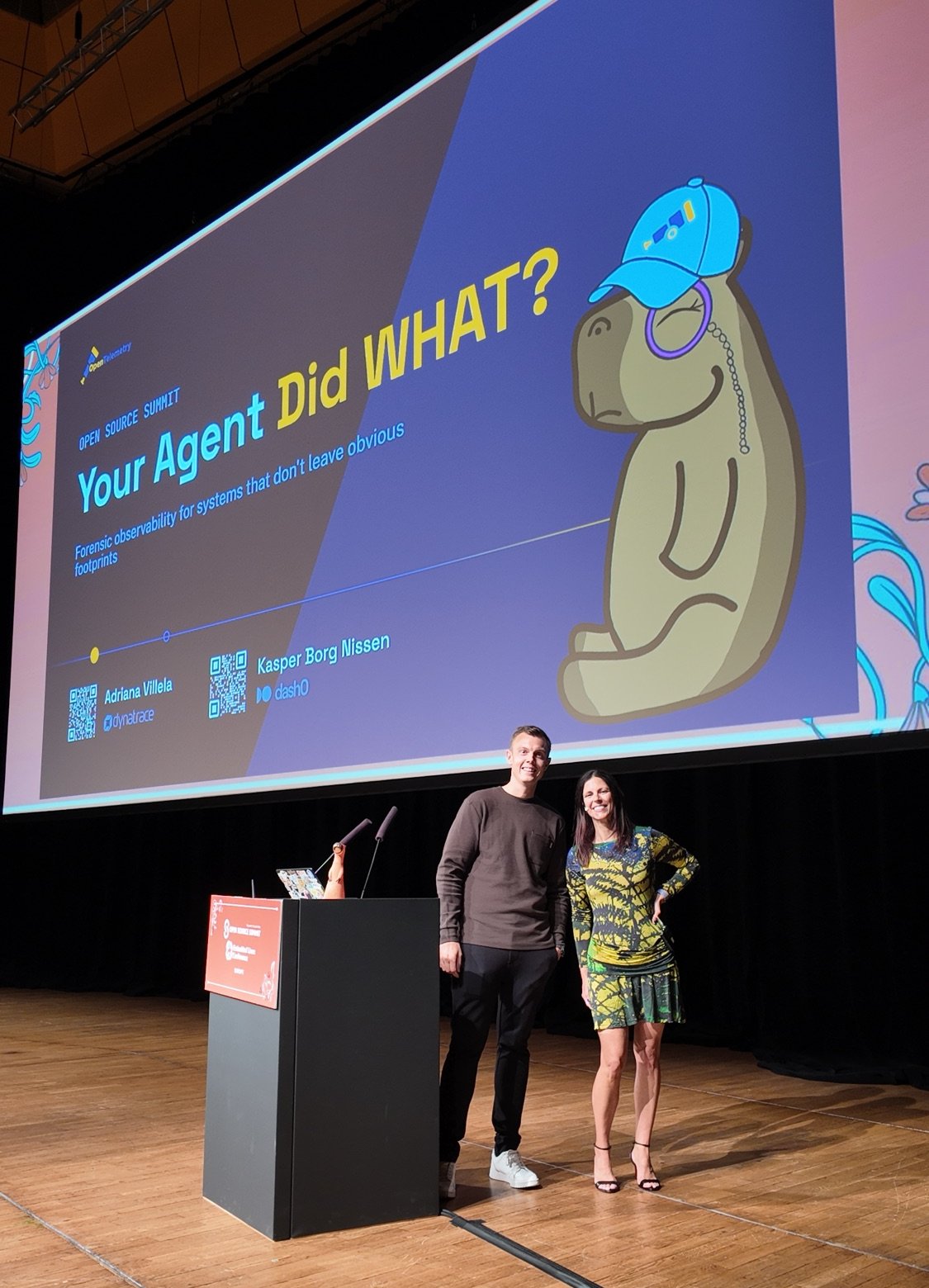 Kasper and Adriana on the Forum Hall stage in front of the Your Agent Did WHAT? title slide